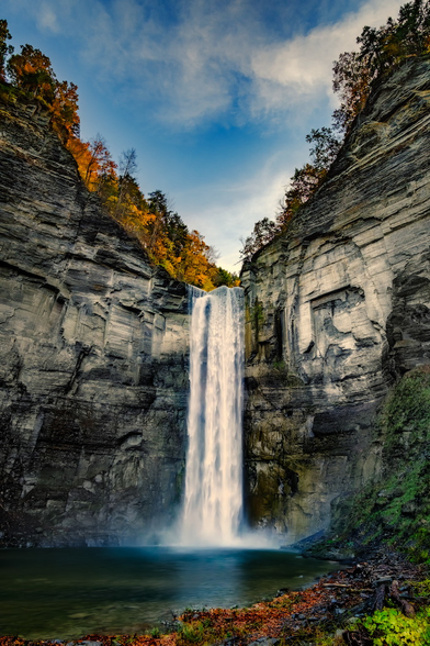Taughannock Falls is in Ulysses, New York, part of the popular Finger Lakes Region of central New York. The falls is within Taughannock State Park. The falls cataract has an incredible drop of 215 feet (66 meters), and is one of the highest east of the Rocky Mountains.
