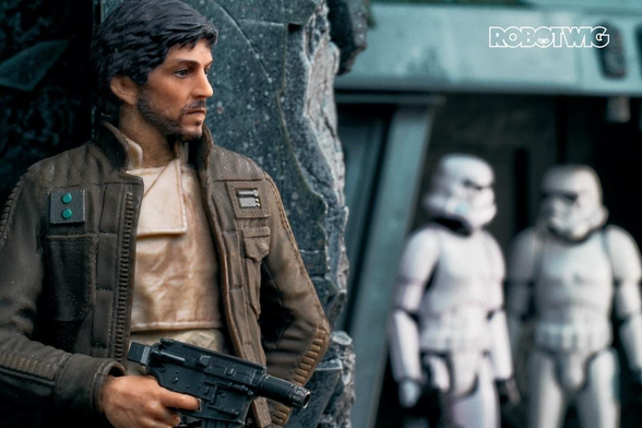 Cassian Andor hides behind a pillar whilst two stormtroopers guard an entrance way