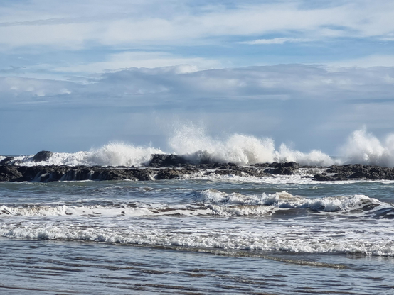 Waves crashing on a reef and spraying upwards