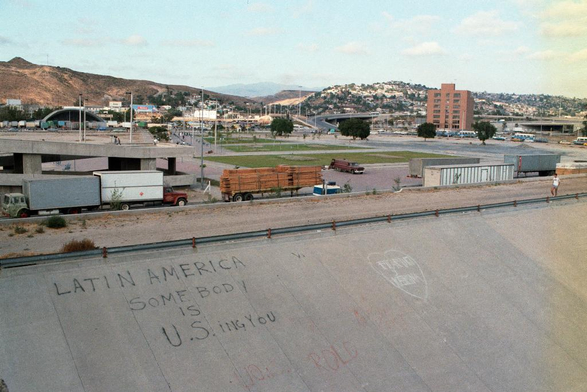 Grafitti on a corridor near the border:

LATIN AMERICA 

Somebody 
        is
U.S. ing you

Kodak Gold 200
Nikon Nikkor 35mm f2.0 AIS 
Nikon FM 