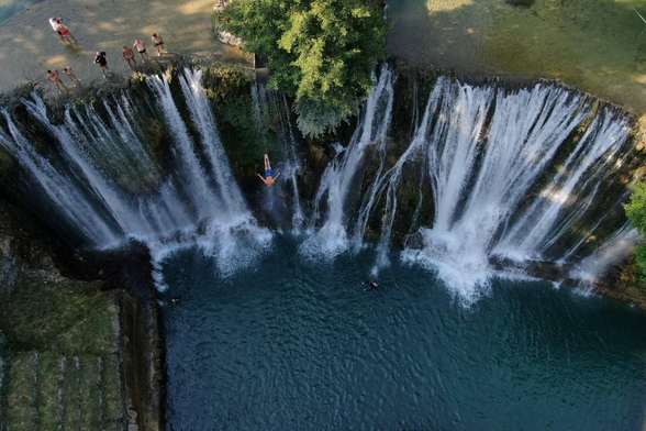 A drone view shows competitors taking part in the annual international waterfall jumping competition.