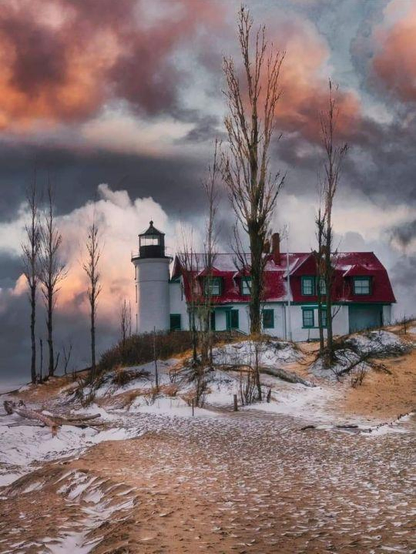 Point Betsie Lighthouse in winter, with some colourful clouds.