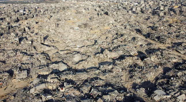 A drone view shows houses and buildings lying in ruins, in Jabalia in the northern Gaza Strip.