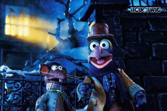 Rizzo and Gonzo stand outside Ebenezer Scrooges house in the dark from a top window comes a beam of light 