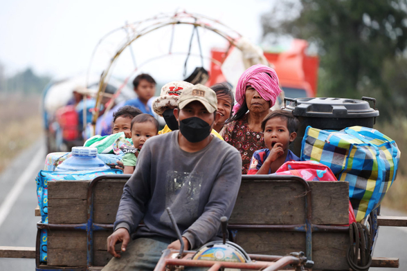 A family cram on to a tractor as they flee.