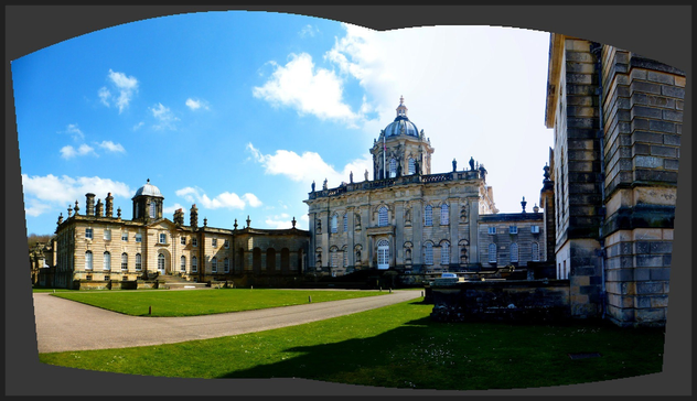 Castle Howard, Yorkshire. Large ornate stately home, in light coloured stone, with dome and pinnacles.