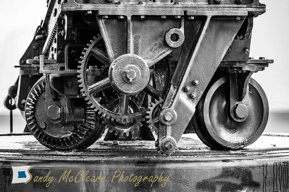 Mechanical gears and wheels on rails. 