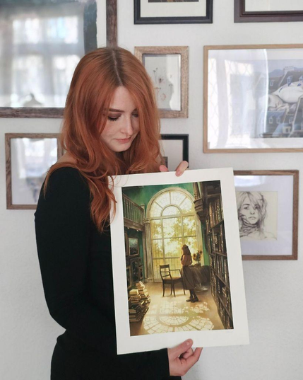 photo of an artist holding an art print