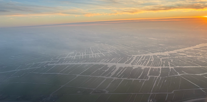 Misty sunset above dutch landscape 