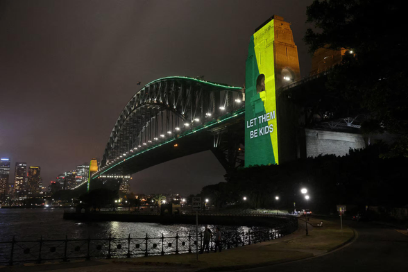A message the reads ‘Let them be kids’ is projected onto the Sydney Harbour Bridge.