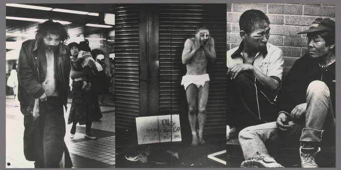 The image is a triptych, composed of three black-and-white photographs depicting individuals in urban settings. The leftmost photo shows an individual walking on the street with disheveled hair and wearing dark clothing; they seem to be carrying something under their arm as they move forward.

In the center photograph, there's another person standing against what appears to be a closed shutter or garage door of a shopfront. This figure has their hands raised near their face in an expression that could suggest distress or exhaustion. The individual is wearing minimal clothing and stands on a sidewalk with other people visible behind them.

The rightmost photo captures two individuals seated together, seemingly engaged in conversation or looking at something off-camera. One person appears to be helping the other put on footwear. Both are dressed casually, one sporting a cap and sports shoes while the other has a wristwatch and is also wearing casual attire with boots.

All three images convey a sense of candidness and capture urban life's gritty realities through their monochrome tones and street-level perspectives. The overall mood appears contemplative or weary, reflecting perhaps on themes like homelessness, hardship, or everyday struggles within an urban environment.