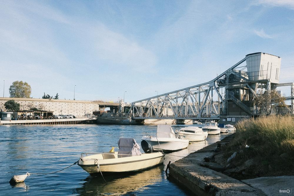 Photographie d'un pont basculant qui enjambe un canal dans lequel se trouve des petits bateaux amarrés. La photographie est issue directement du boitier et est une simulation du film Kodak Ultramax 400.