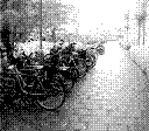 a photo taken with a Gameboy Camera shows the black and white image of a urban sidewalk in Malmo Sweden, a brick pathway with a full row of parked bicycles on one side, an apartment complex on the other side. 