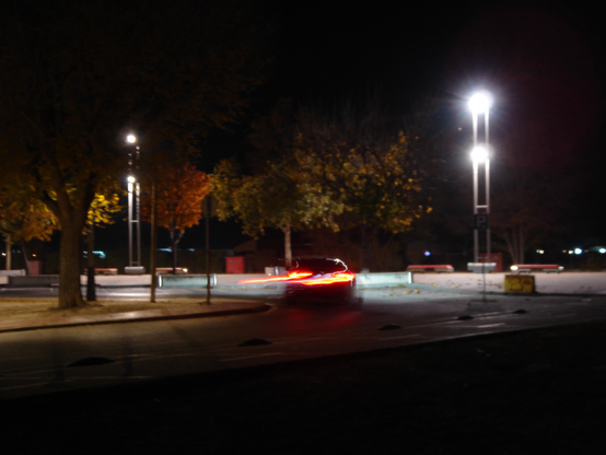                                A picture of a car with a very long exposure causing the rear lights to create a tail in the image