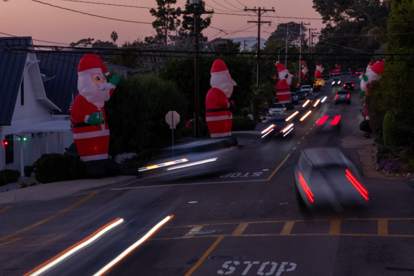 Huge inflatable Santas line Highland Drive, nicknamed Ho Ho Highland.
