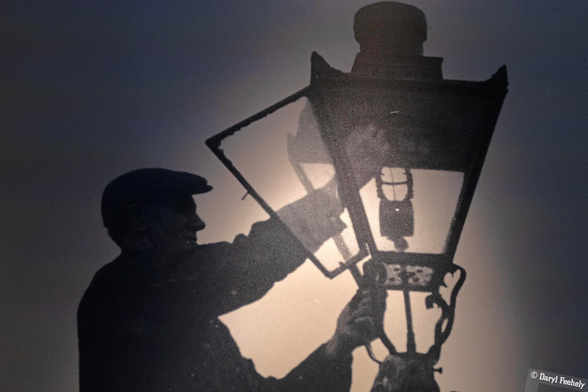 A depiction of a lamp lighter man as a silhouette. 
