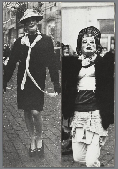 The image is a black and white collage of two separate photographs featuring individuals dressed in elaborate costumes. On the left, there's an individual wearing a straw hat adorned with feathers on top, large earrings hanging from each ear, and a dark dress complemented by a light-colored scarf tied around their neck. They are also sporting high heels.

On the right side of the collage is another person depicted mid-stride in what appears to be a street setting. This individual wears a headscarf or hat with braided details, large round earrings, and has makeup that includes prominent eyeliner. Their attire consists of a dark top layered over lighter-colored clothing, culminating in trousers held up by suspenders.

Both images have a sense of movement captured within the frame, suggesting they were taken during an event where people are walking around. The overall impression is one of a festive occasion or parade.
