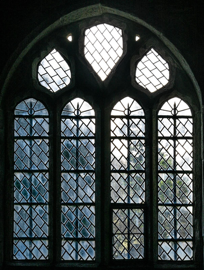 A window in a 15th century English village church, with diagonal lead strips supporting the glass.