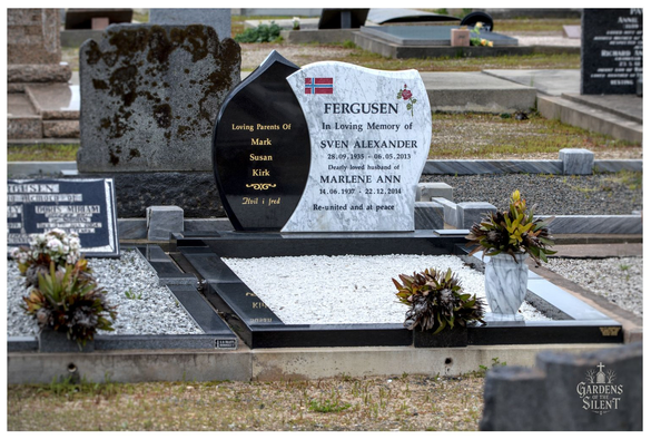 Headstone in a cemetery featuring a unique, wave shaped design split between polished black granite and white/grey marble.  The marble side is inscribed "FERGUSEN" and "In Loving Memory of SVEN ALEXANDER (28.09.1935 - 06.05.2013) Dearly loved husband of MARLENE ANN (14.06.1937 - 22.12.2014) Re-united and at peace."  A small Norwegian flag and rose emblem are above the names. The black granite side lists "Loving Parents Of Mark Susan Kirk" followed by "Hvil i fred."  The grave plot is covered with white gravel and bordered by black granite kerbing, with floral arrangements on either side.