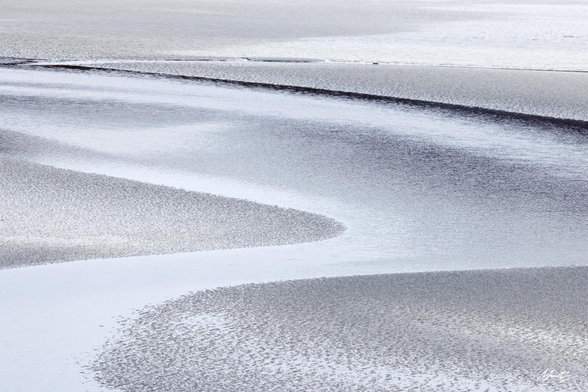 abstract coastal scene of a bay at low tide with sweeping curves. very desaturated almost monochromatic and silvery. 
