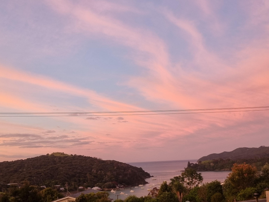 Orange clouds above Doubtless Bay at sunset