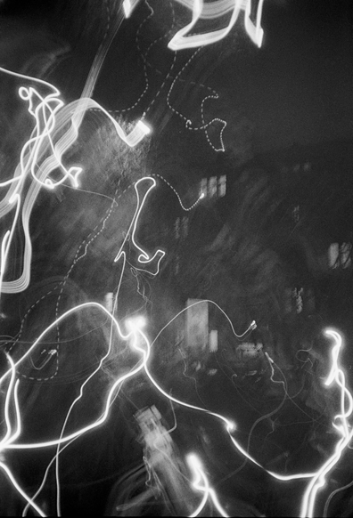 The black-and-white photo shows light abstractions obtained with long exposure.