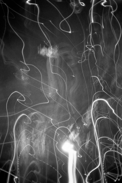 The black-and-white photo shows light abstractions obtained with long exposure.
