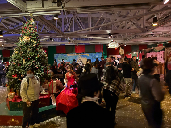 Another crowd scene, with a large decorated Christmas tree.