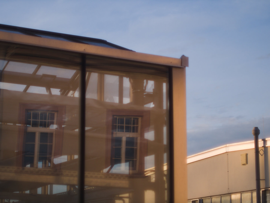 Reflections of a house in a glasshouse