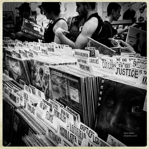 Black and white photo of busy vinyl record store.