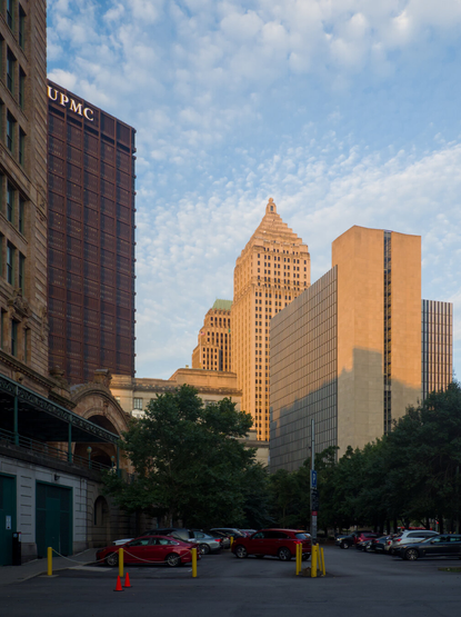 1930s and 1970s skyscrapers in the early morning sun. Partially cloudy.