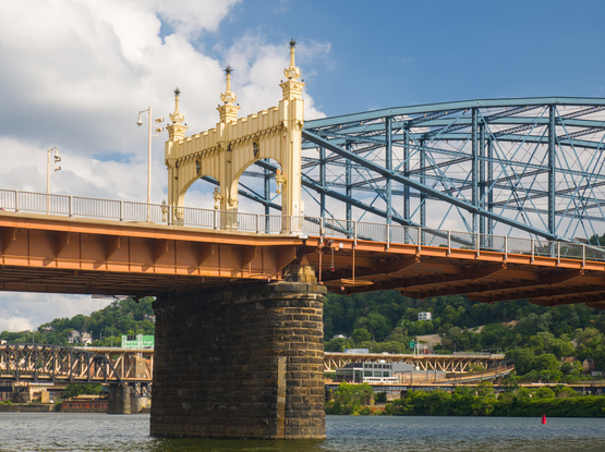 Looking above at the yellow gateway of the Smithfield Bridge