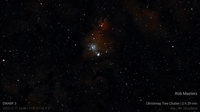 A bright cluster of stars somewhat resembling a Christmas tree illuminate a patch of nebula near the top centre. At the top of the nebula is a triangular incursion with a red glowing tip.  Elsewhere in the shot fainter dust clouds are being illuminated. Text in the corners is replicated in the body text.