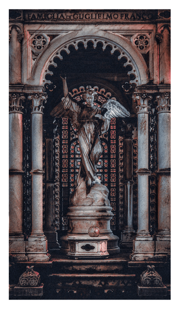 The photo is a weathered stone or marble sculpture of an angel standing within an ornate, classical architectural mausoleum structure. The statue is detailed with wings and draped clothing, and they are standing on a base above a platform with a sphere. The piece features columns, arches, and decorative stained glass latticework in the background. The lighting is dim and dramatic. The inscription "FAMIGLIA di GUGLIELMO FRANCO" "The family of Guglielmo Franco" is visible at the top above the statue.