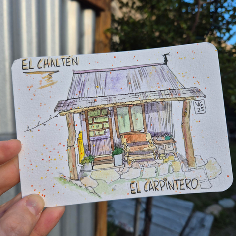 Black marker and watercolor postcard of a tiny house made out if wood and corrugated metal. 