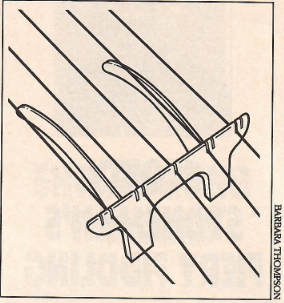 A sketch of what the Jamieson bridge looks like. It feature a flat bridge-shaped piece that makes contact with the strings and banjo head, as well as two long arched legs that reach up and place pressure on the center of the banjo head.