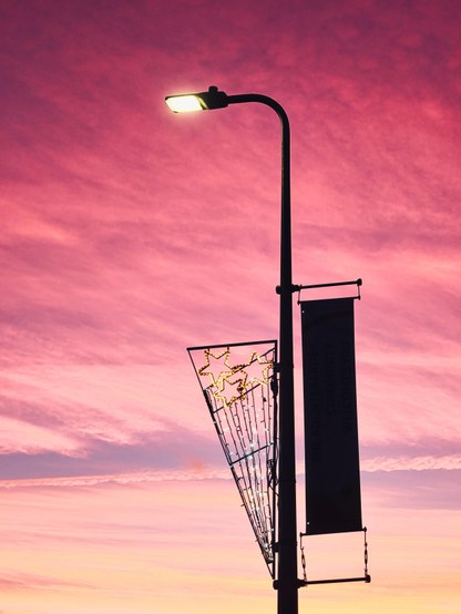 A simple silhouette of mankind against nature - or a streetlight against glorious red & yellow sunset sky, if you're prosaic