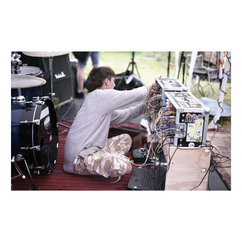 Musician is on the stage next to his synth