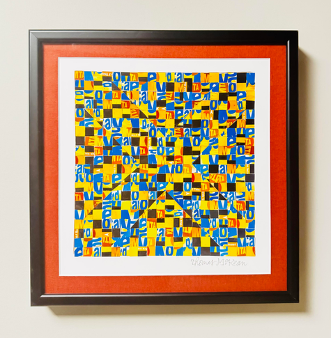 A color photo of a 10 x 10" piece of art. It has a black frame and a rust colored matting on top of a white matting. The art is little pieces of MetroCards that have been cut up. They are in bright blue, bright yellow, black, white and a little red. It looks purely abstract, as though little triangles have been put together but if you step back and squint the colors make an X stand out in the middle