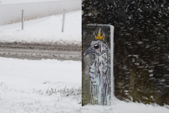 A painting of an eagle head with a crown on glass