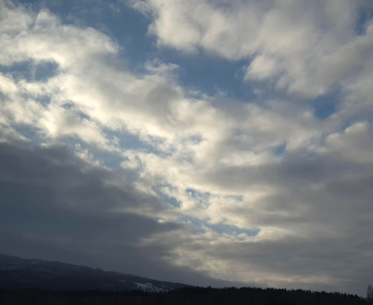 A sky where the grey-white cloud cover has broken up a little and some blue sky is visible. It didn't stay that way for very long...