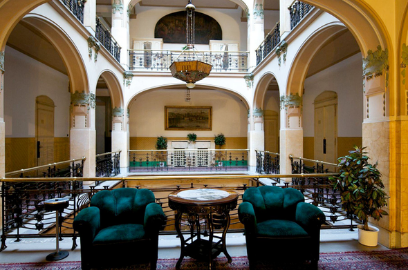 a lobby inside, arched ceilings around the support posts, white and yellow with green, a really cool atmosphere 