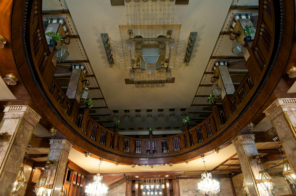 a view from low of one of the ceilings, tones of gold and hanging minimalist designed chandeliers 
