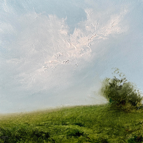 Original landscape oil painting by Tisha Mark, "Homeland No. 2601" oil on Ampersand Gessobord, 6"x6" (2026). A peaceful atmospheric landscape painting of a lush green gentle slope with a loosely painted tree at the right, underneath a soothing light blue sky with textured breezy white cloud formations.