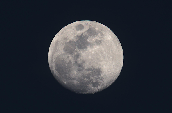 After sunset, but before the sky gets completely dark. The moon dominates the sky.