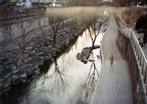 인적 드문 청계천에 누군가 홀로 걷고 있다.