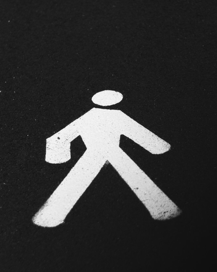a man symbol painted in white marking a footpath