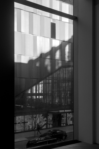 Dramatic light cast on a modern building on Essex Market