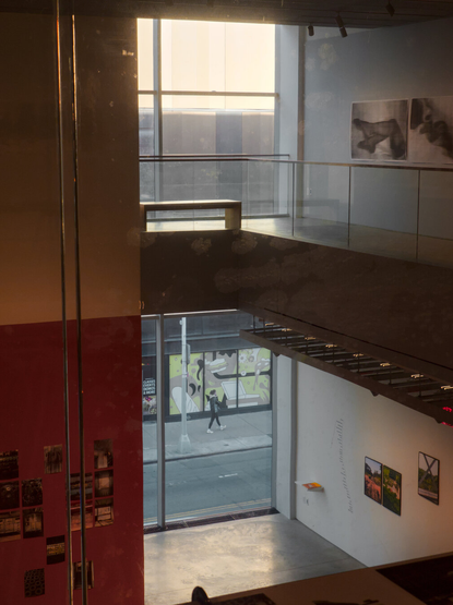 Looking from inside a modern art gallery at Essex Market outside