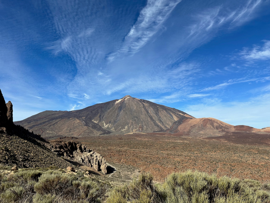 A panorama of Teide National Park with a conical shape of mountain Teide in the centre
